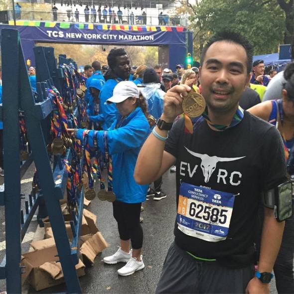 Posing with the finisher medal at the 2017 NYC Marathon